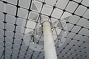 Bare concrete column with suspended ceiling