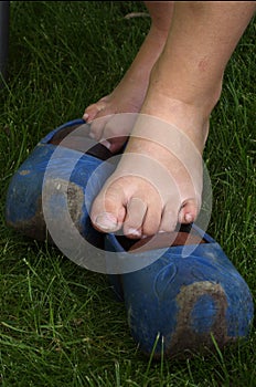 Bare feet on blue wooden shoes