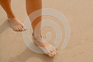 Bare Feet Coated in Sand Walking on Beach