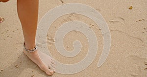 Bare Feet Coated in Sand Walking on Beach