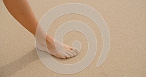 Bare Feet Coated in Sand Walking on Beach