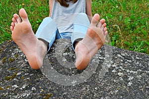 Bare feet of girl on stone