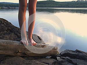 Bare feet by a lake