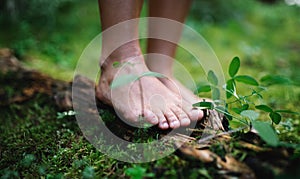 Bare feet of man standing barefoot outdoors in nature, grounding concept. photo