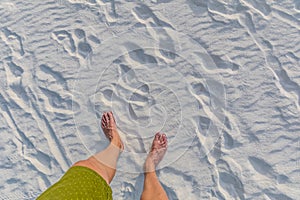 Bare feet of a man standing on sand. Concept of vacation, relaxation, freedom or refreshment