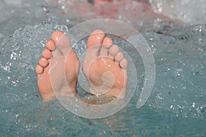 Bare feet out of bubbling water