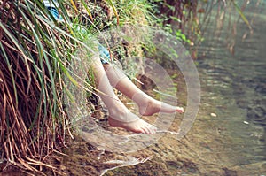 Bare feet of the river. A child enjoying the outdoors.