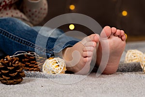 Bare feet of a small child. Cozy Christmas mood.