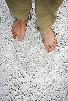 Bare feet on snowy grass