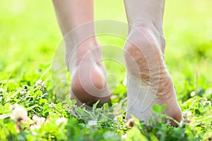 Bare feet on the soft summer grass