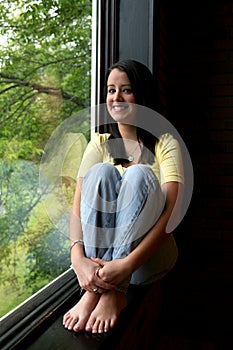 Bare feet teen by window