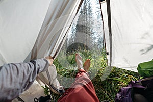 Bare feet from a tent in a hike in nature, outdoor recreation