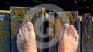 Bare feet on wooden boards with moving toes
