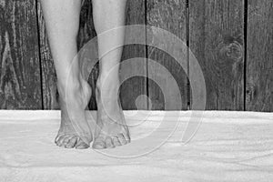Bare feet of a young girl on the carpet at home on the floor