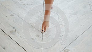 Bare feet of a young girl walking