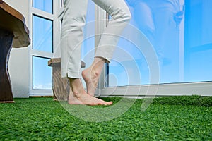 Bare female legs on the balcony