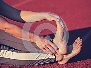 Bare foot mature woman stretching tendons and ankles