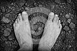 Bare foots over dry soil photo