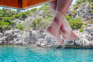 Bare hanging from wooden pier over sea water. Holiday vacation by the sea