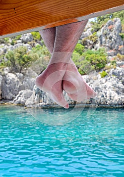 Bare hanging from wooden pier over sea water. Holiday vacation by the sea