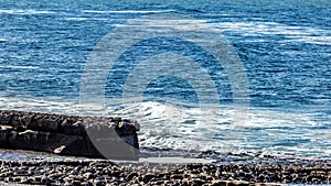 Bare limestone landscape in Doolin bay next to pier