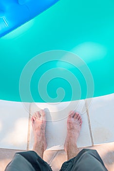 Bare male feet by the poolside