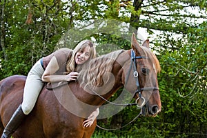 Bareback woman rider hugging her horse