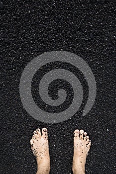Barefeet in black sand
