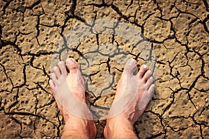 Barefeet on dry soil. photo