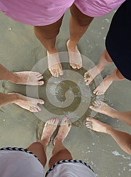 barefeet of a family bathed on the shore