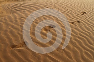 Barefeet footprints on the sand dune
