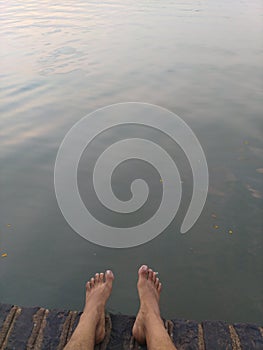 Barefeet in the water relaxing