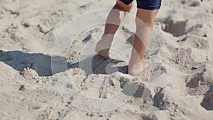 barefoot baby toddler feet walking white sand beach. kid's barefoot legs step