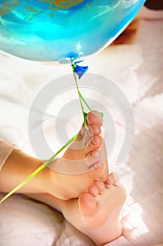 Barefoot and blue balloon close up. Valentine`s Day, Birthday and party celebration