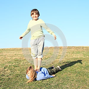 Barefoot boy standing on girl