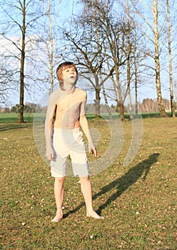 Barefoot boy standing on grass