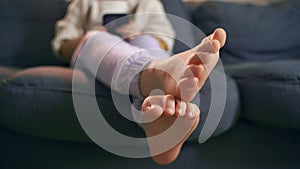 Barefoot Child Relaxing on Couch