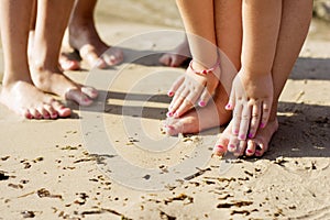 Barefoot family in the sand