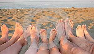 Barefoot of a family on the shore of the sea on the beach