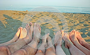 Barefoot of a family on the shore of the sea on the beach with c
