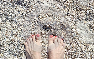 Barefoot feet on sand coast