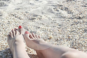 Barefoot feet on sand coast