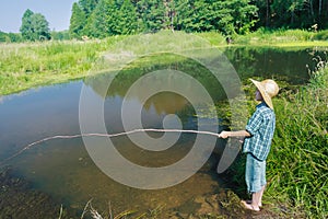 Barefoot fishing boy standing in transparent