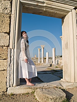 Barefoot Girl Leaning Ancient Ruins