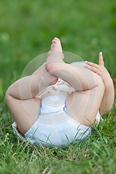 Barefoot girl lying in a meadow