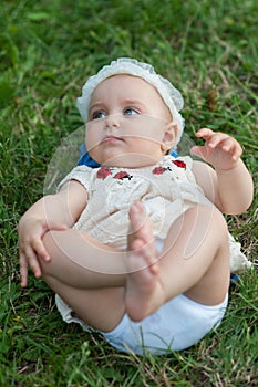 Barefoot girl lying in a meadow