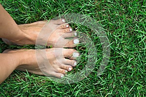 Barefoot girl on the soft summer grass