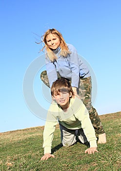 Barefoot girl stepping on boy