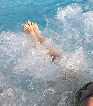 Barefoot girl while taking bath in the thermal pool