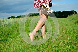 Barefoot girl walks on grass